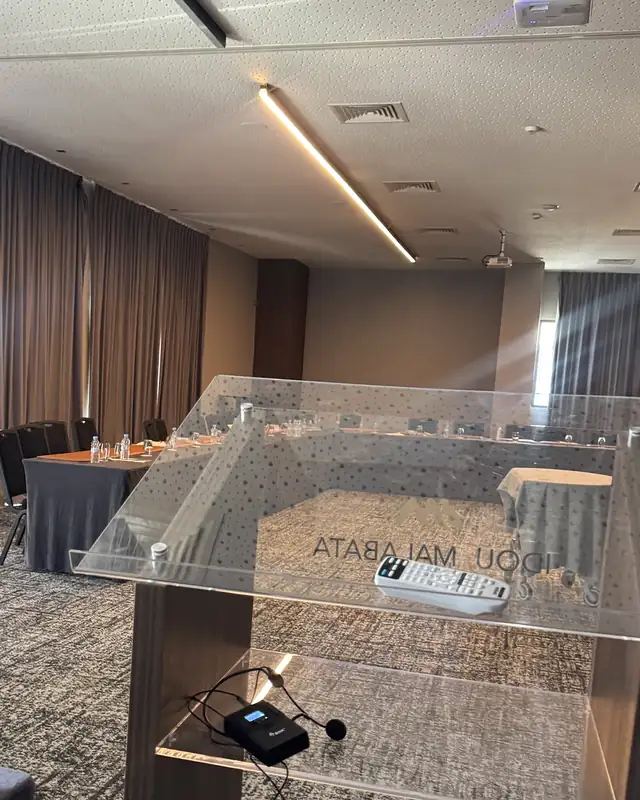Lectern facing a U-shaped table in a hotel meeting room in Tangier, set up before an executive committee training